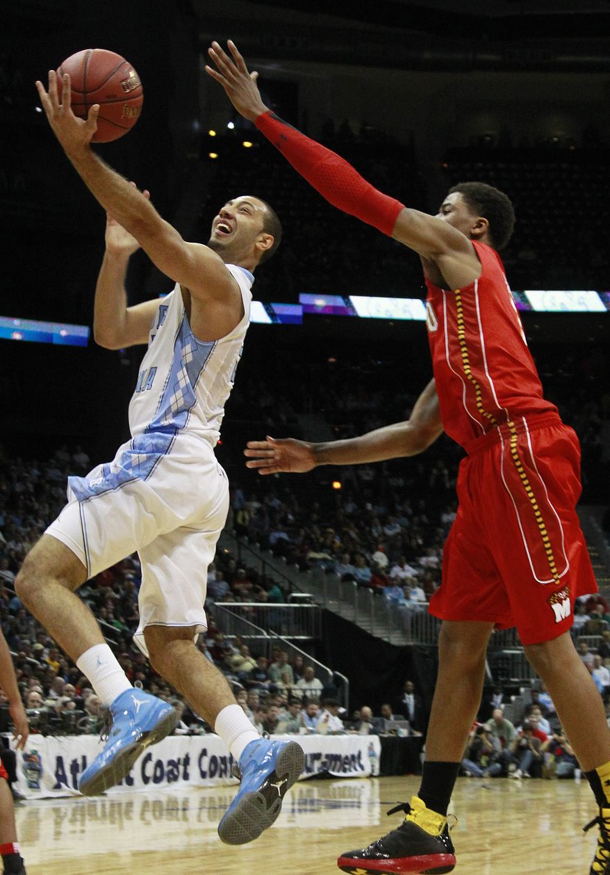 North Carolina guard Kendall Marshall heads to the basket as Maryland guard Nick Faust defends during the first half in the quarterfinals of the ACC tournament, Friday, March 9, 2012, in Atlanta. (AP Photo/John Bazemore)