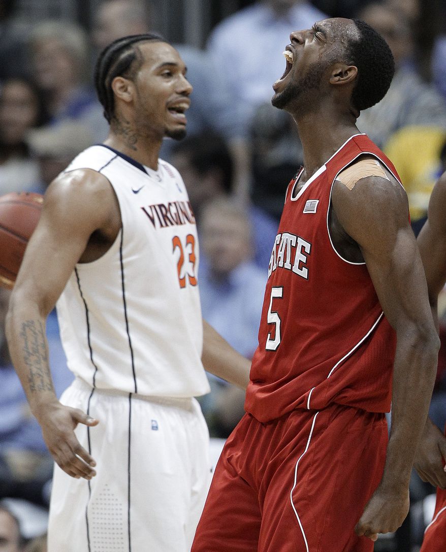 North Carolina State forward C.J. Leslie reacts after scoring as Virginia forward Mike Scott stands nearby during the first half in the quarterfinals of the ACC tournament, Friday, March 9, 2012, in Atlanta. (AP Photo/Chuck Burton)