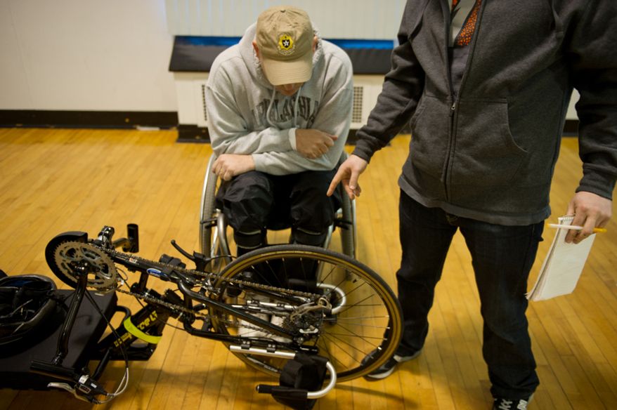 Lt. Col. Danny Dudek of Fort Belvoir talks about his hand bike with Eugene Halpin, right, a civilian with the Rehabilitation institute of Chicago before competing with other wounded soldiers and Army veterans from across the United States in the Army Warrior Games clinics for a chance at a spot on the Army Warrior Games team, Fort Meade, Md., Sunday, March 11, 2012. The 2012 Warrior Games, held April 30th - May 5th in Colorado Springs, Colo., features representatives from Army, Navy, Air Force, Marines and Special Operations and will compete for gold metals in archery, cycling, wheelchair basketball, shooting, swimming, track and field, and sitting volleyball. (Andrew Harnik/The Washington Times)