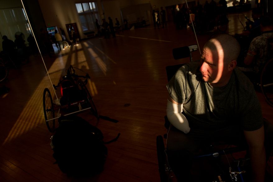 Sgt. Brian Bradley from Ohio who lost a portion of his right arm from large caliber rifle fire Nov. 2010 in Afghanistan gets ready to compete in recumbent cycling with other wounded soldiers and Army veterans from across the United States in the Army Warrior Games clinics for a chance at a spot on the Army Warrior Games team, Fort Meade, Md., Sunday, March 11, 2012. The 2012 Warrior Games, held April 30th - May 5th in Colorado Springs, Colo., features representatives from Army, Navy, Air Force, Marines and Special Operations and will compete for gold metals in archery, cycling, wheelchair basketball, shooting, swimming, track and field, and sitting volleyball. (Andrew Harnik/The Washington Times)