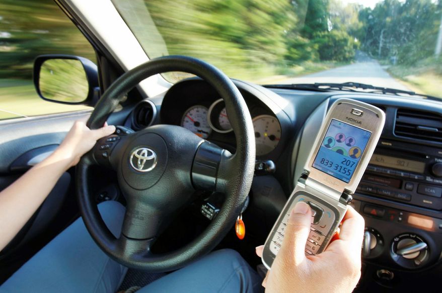 Drivers using cell phones and other devices, whether in the dashboard or hand-held, are the subject of distracted-driving debates. (Associated Press)