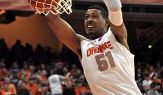 ** FILE ** In this Jan. 14, 2012, file photo, Syracuse&#x27;s Fab Melo dunks against Providence. Melo did not travel with the team to Pittsburgh and the university says he won&#x27;t take part in the NCAA tournament because of an eligibility issue. The school would not elaborate. (AP Photo/Kevin Rivoli, File)