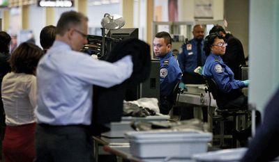 Transportation and Security Administration workers screen passengers at Ronald Reagan Washington National Airport last month. Some air travelers over the age of 75 will soon get a break at airport security checkpoints under a test program. (Associated Press)