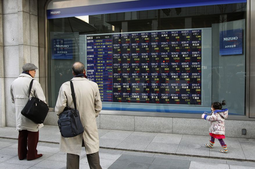 Men look at an electronic stock indicator in Tokyo, Wednesday, March 14, 2012. Asian stock markets rose Wednesday, powered by the biggest gains of the year on Wall Street after the U.S. Federal Reserve said it expects unemployment in the world's largest economy to keep falling. (AP Photo/Shizuo Kambayashi)
