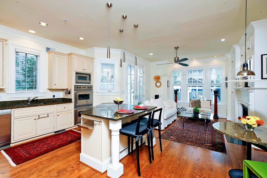 At the rear of the main level are the open center-island kitchen, breakfast area and family room. Plenty of windows bathe the home in natural light.