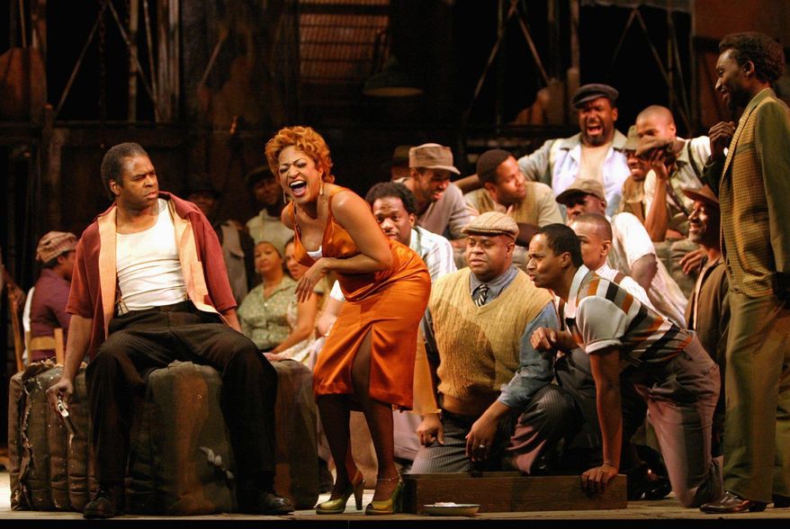 Terry Cook as the murderous, possessive Crown (seated) and Indira Mahajan as Bess rehearse for Washington National Opera's recent production of "Porgy and Bess." (Washington National Opera via Associated Press)