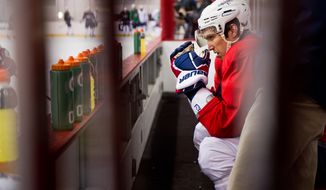 Washington Capitals left wing Alex Ovechkin sits on the bench March 15, 2012, after colliding with teammate Mike Knuble during a morning practice at Kettler Capitals Iceplex in Arlington, Va. (Andrew Harnik/The Washington Times)
