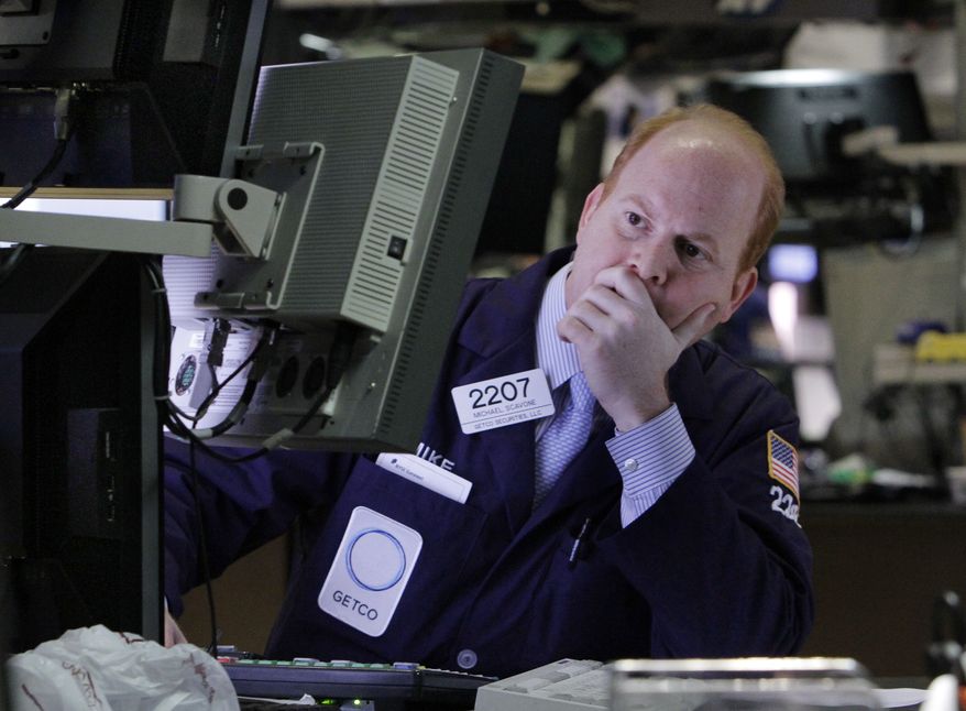 Specialist Michael Scavone works at his post on the floor of the New York Stock Exchange on Thursday, March 15, 2012, in New York. (AP Photo/Richard Drew)