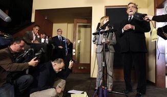 Attorneys John Henry Browne, right, and Emma Scanlan, second from right, talk to reporters, Thursday, March 15, 2012, in Seattle. Browne and Scanlan will be representing a U.S. soldier accused of killing 16 Afghan civilians. (AP Photo/Ted S. Warren)