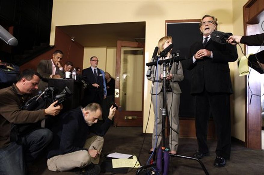 Attorneys John Henry Browne, right, and Emma Scanlan, second from right, talk to reporters, Thursday, March 15, 2012, in Seattle. Browne and Scanlan will be representing a U.S. soldier accused of killing 16 Afghan civilians. (AP Photo/Ted S. Warren)