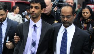 Dharun Ravi (center) is hugged by his father, Ravi Pazhani, on March 16, 2012, as they leave court in New Brunswick, N.J. Ravi, a former Rutgers University student accused of using a webcam to spy on his gay roommate&#x27;s love life, was convicted of bias intimidation and invasion of privacy. (Associated Press)