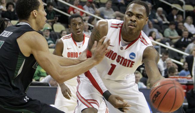 Ohio State&#x27;s Deshaun Thomas passes around Loyola&#x27;s Erik Etherly during the second half of an East Regional NCAA tournament first-round college basketball game in Pittsburgh, Thursday, March 15, 2012. ( AP Photo/Gene J. Puskar)
