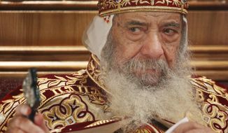 ** FILE ** In this April 18, 2009, file photo, Pope Shenouda III, the head of Egypt&#x27;s Coptic Orthodox Church, leads a midnight service to celebrate Christ&#x27;s resurrection, at the Coptic Cathedral in Cairo, Egypt. (AP Photo/Ben Curtis, File)