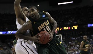 Norfolk State&#x27;s Kyle O&#x27;Quinn is defended by Missouri&#x27;s Steve Moore in their NCAA tournament second-round college basketball game at CenturyLink Center in Omaha, Neb., Friday, March 16, 2012. Norfolk State won 86-84, and O&#x27;Quinn had 26 points and 14 rebounds. (AP Photo/Nati Harnik)