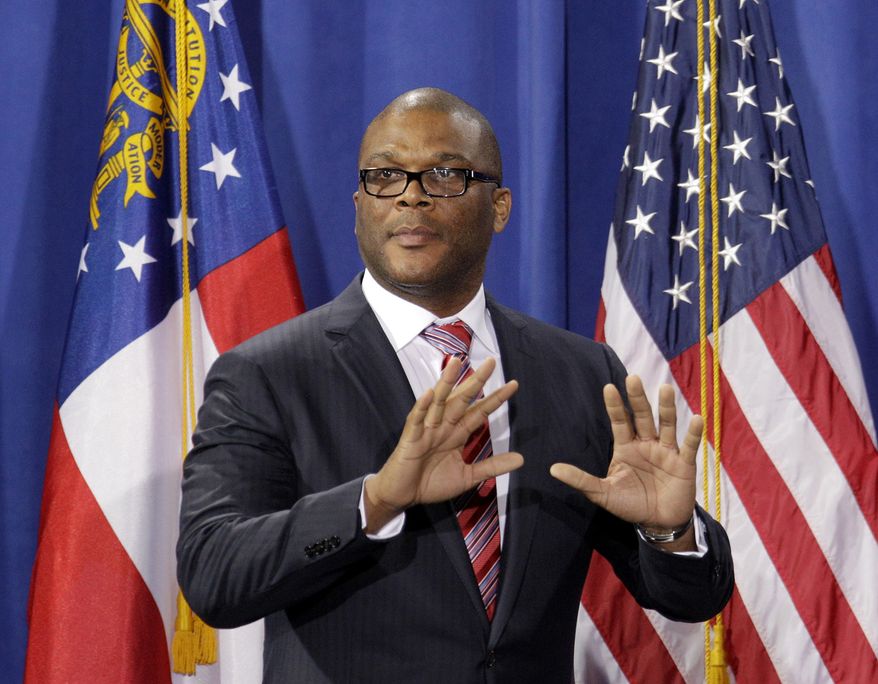 Actor Tyler Perry takes the stage to introduce President Obama during a fundraiser at Mr. Perry's film studio on Friday, March 16, 2012, in Atlanta. (AP Photo/David Goldman)