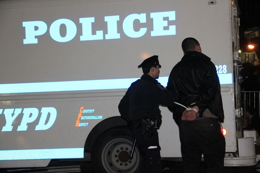 Police arrest an Occupy Wall Street protester early on Sunday, March 18, 2012, in Zuccotti Park in New York after a march in celebration of the protest's sixth month. (AP Photo/Albert Sabate)