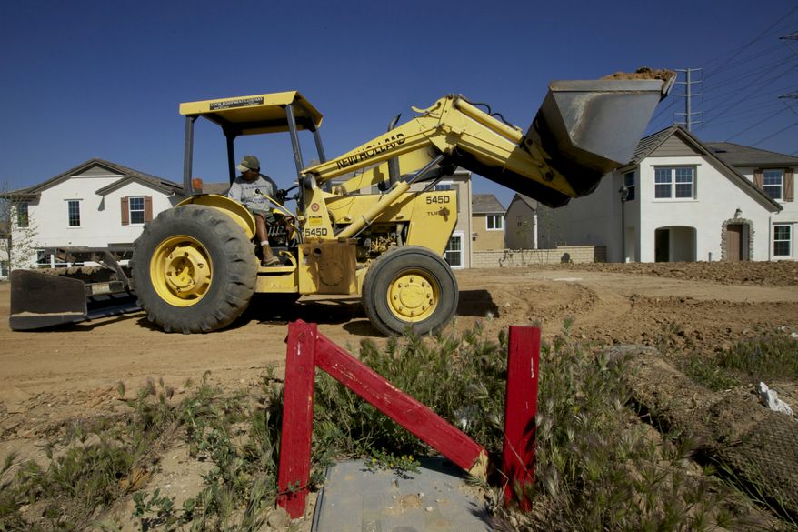 A skid-steer-loader flattens the land for a new single-family detached home being built by Lennar at the Aria at West Creek development in Santa Clarita, Calif., on Thursday, March 15, 2012. (AP Photo/Damian Dovarganes)