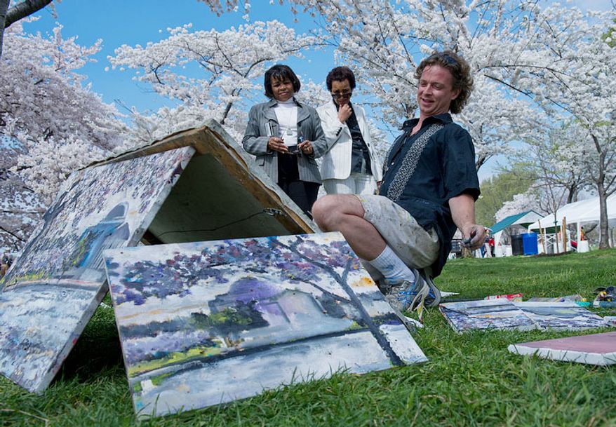 Painter Justin Pyles, of Washington, D.C., leans back to get some perspective on his painting of the cherry blossoms along the Tidal Basin in D.C., on March 19, 2012, while two passers-by stop to admire his work. Pyles came out to paint before going in to work at the Smithsonian. He says he has painted the cherry blossoms every year for about the past 12 years. (Barbara L. Salisbury/The Washington Times)