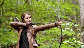 Jennifer Lawrence portrays Katniss Everdeen, a tough &quot;tribute&quot; from an outlying district who is brought to the Capitol to fight for her life in &quot;The Hunger Games.&quot; (Lionsgate via Associated Press)