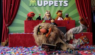 Jim Henson&#39;s puppet character Sweetums the ogre shows off the star with other Muppets characters as they are honored on the Hollywood Walk of Fame in Los Angeles on Tuesday. Kermit, Miss Piggy and Fozzie Bear were also on hand for the honor. (Associated Press)