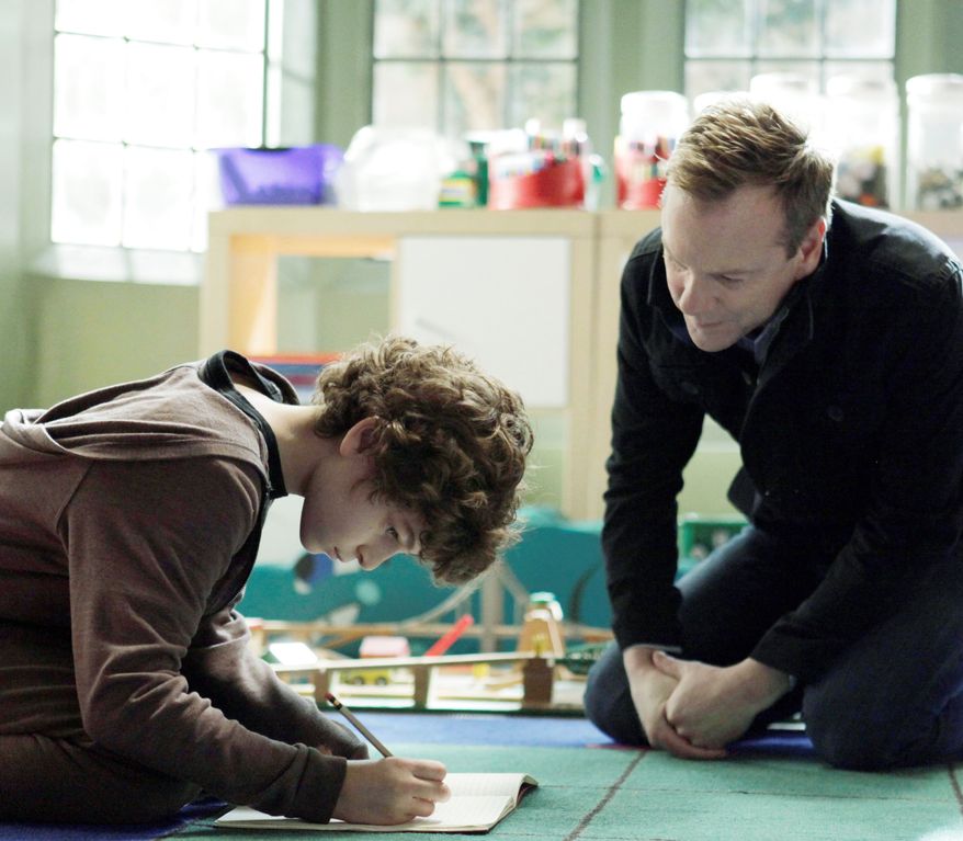 Kiefer Sutherland is the father of a son played by David Mazouz, who is mute but has an outsized ability with numbers, in the new TV series "Touch." It debuts Thursday on Fox. (Fox Television via Associated Press)