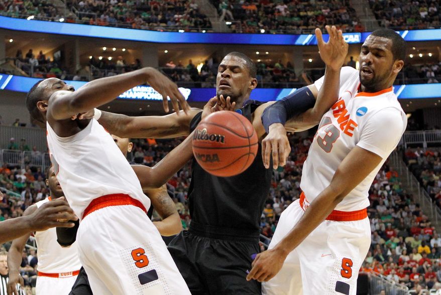 C.J. Fair (left) and James Southerland gang up on Kansas State's Jordan Henriquez in Syracuse's opening victory. The Orange play Wisconsin at 7:15 p.m. Thursday. (Associated Press)
