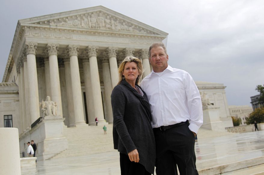 ** FILE ** In this Oct. 14, 2011, file photo, Mike and Chantell Sackett of Priest Lake, Idaho, pose for a photo in front of the Supreme Court in Washington. The Supreme Court ruled unanimously Wednesday that property owners have a right to prompt review by a judge of an important tool used by the Environmental Protection Agency to address water pollution. (AP Photo/Haraz N. Ghanbari, File)

