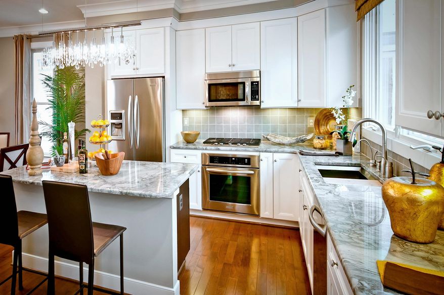 The Bryant model has four finished levels with an open living room and dining room on the main level along with a center-island kitchen and breakfast area. Each home has a roof terrace and buyers can add a deck off the main level.