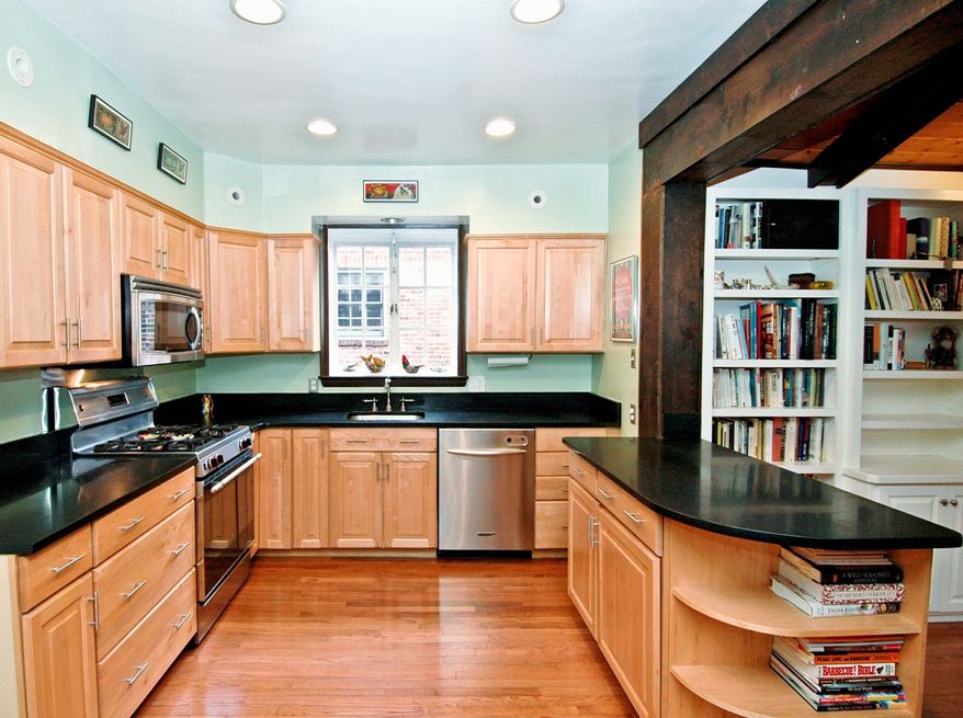 The kitchen, which was remodeled in 2006, has stainless steel appliances, black granite counters and maple cabinets. The kitchen opens onto the family room.