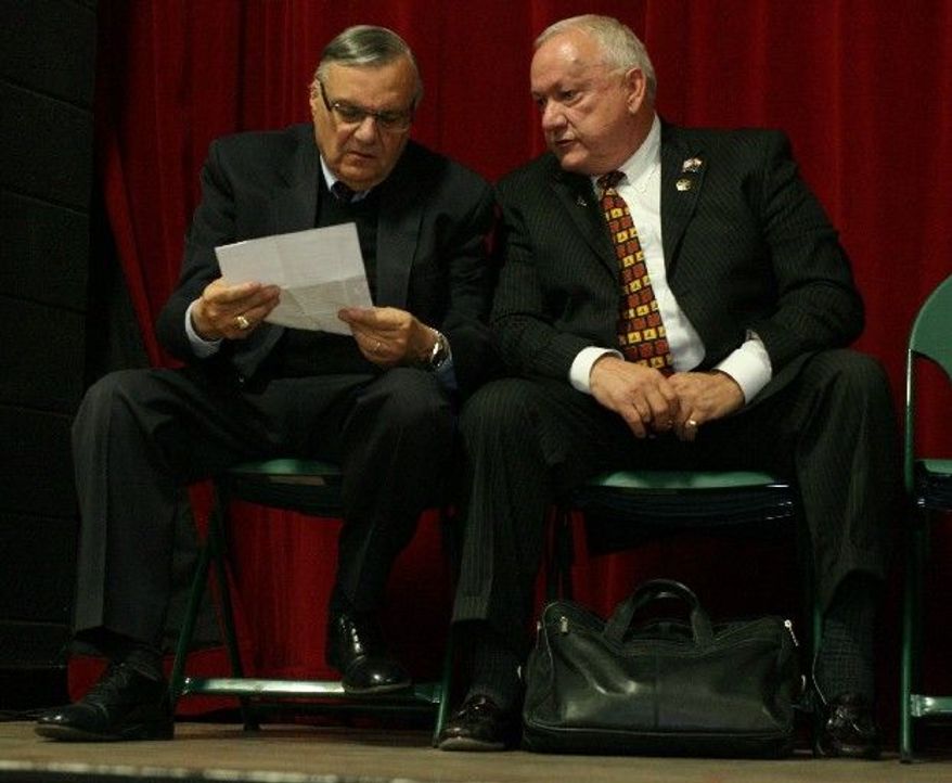Maricopa County Sheriff Joe Arpaio (left) and Russell Pearce attend an Arizona Red Mountain Tea Party meeting in Mesa, Ariz., on Monday. The sheriff is in a tough fight to stay in office and Mr. Pearce is trying to regain a seat in his state's Senate. (East Valley Tribune via Associated Press)