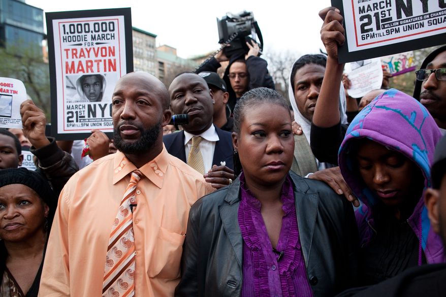 ** FILE ** Trayvon Martin's parents Tracy Martin (left) and Sybrina Fulton (center) are joined by an unidentified woman during the Million Hoodie March in New York City's Union Square on March 21, 2012. A few hundred people marched in memory of Trayvon Martin, a black teenager shot to death by a Hispanic neighborhood watch captain in Florida. The teenager was unarmed and was wearing a hoodie. (Associated Press)