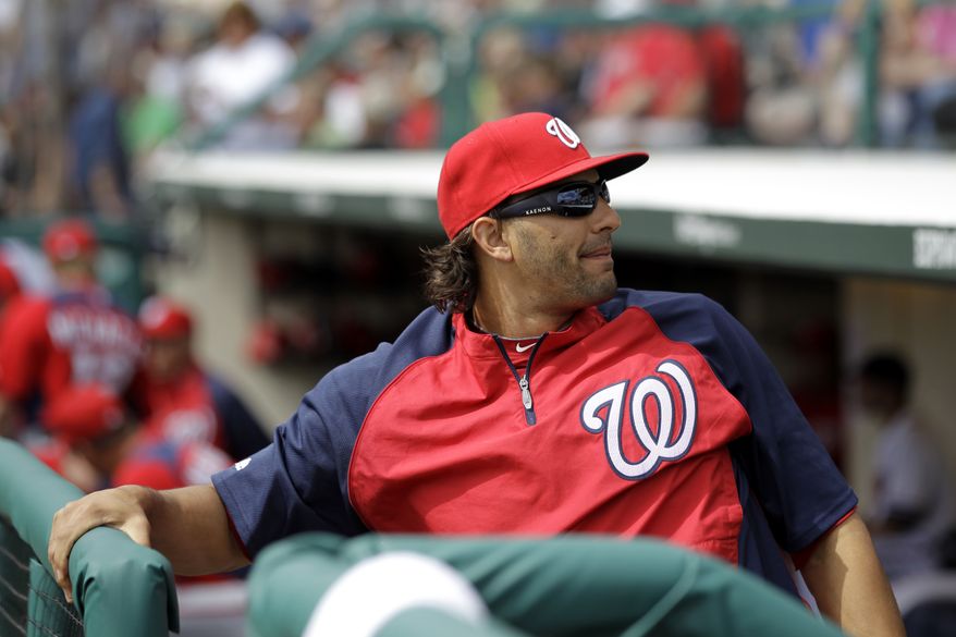 **FILE** Washington Nationals outfielder Michael Morse sits on the bench moments before the start of a spring training baseball game against the Atlanta Braves on March 6, 2012, in Lake Buena Vista, Fla. Morse was scratched off the starting line up because he felt discomfort in his back while warming up. The Nationals won 5-2. (Associated Press)