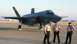 **FILE** Lockheed Martin Corp. security guards stand in front of a new stealth fighter, known as the F-35 or Joint Strike Fighter, before a news conference after the plane&#39;s first flight in Fort Worth, Texas, on Dec. 15, 2006. (Associated Press)