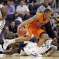 Florida&#39;s Bradley Beal (23) moves past Marquette&#39;s Jae Crowder (32) as Marquette&#39;s Junior Cadougan watches during the first half of an NCAA men&#39;s college basketball tournament West Regional semifinal on Thursday, March 22, 2012, in Phoenix. (AP Photo/Chris Carlson)