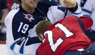Winnipeg Jets center Jim Slater fights with Washington Capitals center Brooks Laich during the second period Friday, March 23, 2012, in Washington. (AP Photo/Evan Vucci)
