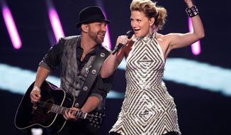 Jennifer Nettles and Kristian Bush (left) of the band Sugarland were about to perform Aug. 13 at the Indiana State Fair when the stage and rigging collapsed, killing seven people and injuring dozens. Miss Nettles has been ordered to give a deposition in the lawsuits that followed. (Associated Press)