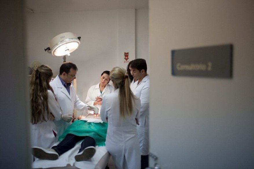 Barbara Penha receives radio-frequency treatment on her abdomen at the Brazilian Society of Aesthetic Medicine in Rio de Janeiro. She receives the treatment free of charge at the clinic that provides the poor access to cosmetic treatments. "We're actually treating something very important - the patient's self esteem," says Dr. Nelson Rosas (left). The philosophy behind more than 200 such clinics across Brazil is that beauty is a right, and that the poor deserve to be ravishing, too. (Associated Press)