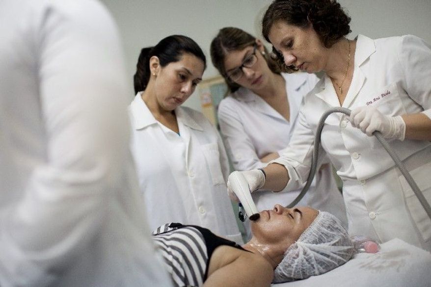 Nilcea Furtado receives free radio-frequency treatment from Dr. Ana Paula to remove bothersome hairs from her chin. "I never knew what it was to look into the mirror and like what I saw," Ms. Furtado says. "It's an amazing feeling." (Associated Press)