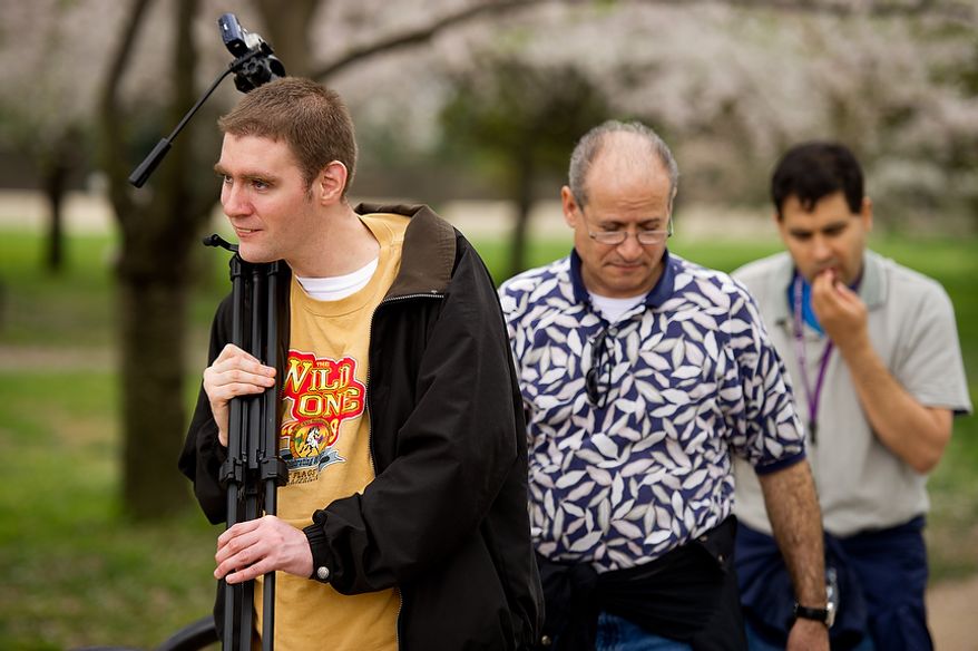 Autistic adults Matt D., left, and Jimmie R., right, with Community Services for Autistic Adults and Children, based in Montgomery Village, Md., are accompanied by staff member Renee Gonzales, center, as they take photographs of the Cherry Blossoms along the Tidal Basin, Washington, D.C., Wednesday, March 21, 2012. The “InFocus Project†is a way for adults with autism to develop forms of self expression and social skills while producing work that has been featured in art shows, given to donors to C.S.A.A.C., and sold on an online store. (Andrew Harnik/The Washington Times)