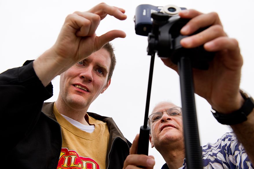 Staff member Renee Gonzales, right, with Community Services for Autistic Adults and Children, based in Montgomery Village, Md., helps autistic adult Matt D., left, take photographs of the Cherry Blossoms along the Tidal Basin, Washington, D.C., Wednesday, March 21, 2012. The “InFocus Project†is a way for adults with autism to develop forms of self expression and social skills while producing work that has been featured in art shows, given to donors to C.S.A.A.C., and sold on an online store. (Andrew Harnik/The Washington Times)