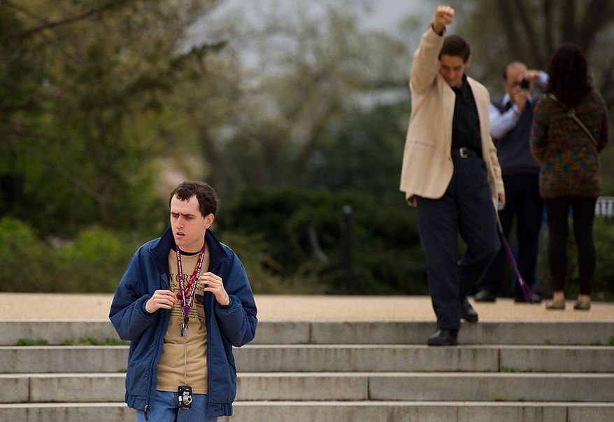 Matt D., left, and James L., second from left, walk around with their cameras near the Jefferson Memorial as they and other autistic adults with Community Services for Autistic Adults and Children, based in Montgomery Village, Md., take photographs of the Cherry Blossoms along the Tidal Basin, Washington, D.C., Wednesday, March 21, 2012. The “InFocus Project†is a way for adults with autism to develop forms of self expression and social skills while producing work that has been featured in art shows, given to donors to C.S.A.A.C., and sold on an online store. (Andrew Harnik/The Washington Times)