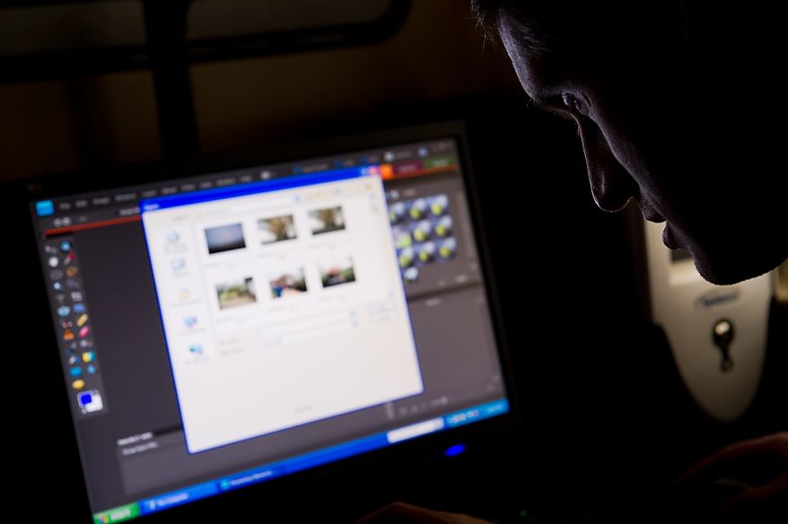 Autistic adult James L. edits his photographs of the Cherry Blossoms taken along the Tidal Basin at a computer lab at the Community Services for Autistic Adults and Children, Montgomery Village, Md., Thursday, March 22, 2012. James is part of the “InFocus Project†which helps adults with autism to develop forms of self expression and social skills while producing work that has been featured in art shows, given to donors to C.S.A.A.C., and sold on an online store. (Andrew Harnik/The Washington Times)