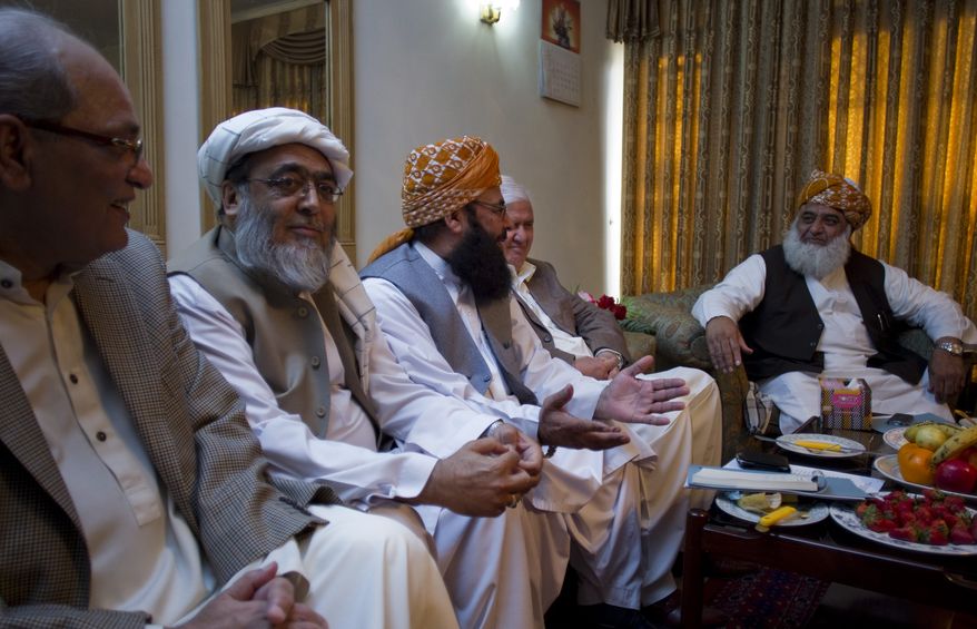 Maulana Fazal-ur-Rehman (right), chief of the Pakistani religious party Jamiat Ulema-e-Islam, heads a meeting of opposition leaders on Saturday, March 24, 2012, in Islamabad to discuss strategy for the forthcoming Parliament debate on the terms of re-engagement with United States. (AP Photo/B.K. Bangash)