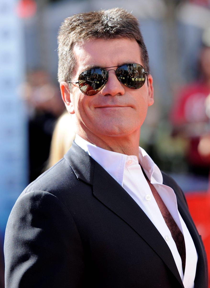 "The X Factor" producer Simon Cowell was "shaken up" after a woman allegedly broke into his home wielding a broken brick. The suspect, Leanne Zaloumis, 29, was charged with aggravated burglary after the incident Saturday night. (Associated Press)