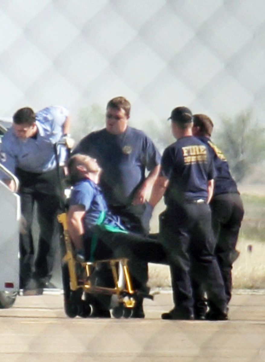 ASSOCIATED PRESS PHOTOGRAPHS
Emergency workers tend to a JetBlue captain who was locked out of the cockpit by crew members during a New York-to-Las Vegas flight on Tuesday because of his behavior. Passengers said the pilot ranted about a possible bomb onboard.