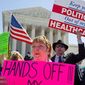 **FILE** Kathy Hansen, a family practice doctor in Houston, protests President Obama&#39;s health care law outside the Supreme Court on March 27, 2012. The justices were listening to arguments on the law&#39;s individual mandate. (The Washington Times)