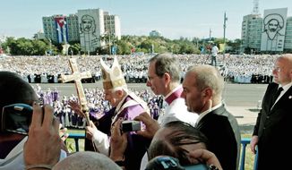Pope Benedict XVI arrives to lead an open-air Mass at Revolution Square in Havana on Wednesday, his last day in Cuba. The square includes an image of Communist hero Ernesto &quot;Che&quot; Guevara (background, left). (Associated Press)