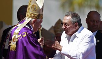 Pope Benedict XVI (left) speaks with Cuban President Raul Castro at the end of an open-air Mass in Revolution Square in Havana on Wednesday, March 28, 2012. (AP Photo/Ramon Espinosa)

