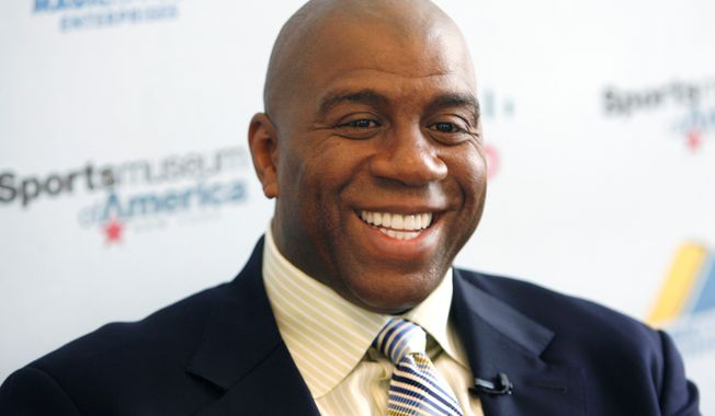 Basketball legend turned entrepreneur Magic Johnson tours the Sports Museum of America in New York, Friday, Nov. 21, 2008. A group that includes former Lakers star Magic Johnson and longtime baseball executive Stan Kasten agreed Tuesday night March 27, 2012, to buy the Los Angeles Dodgers from Frank McCourt for $2 billion. (AP Photo/Seth Wenig)