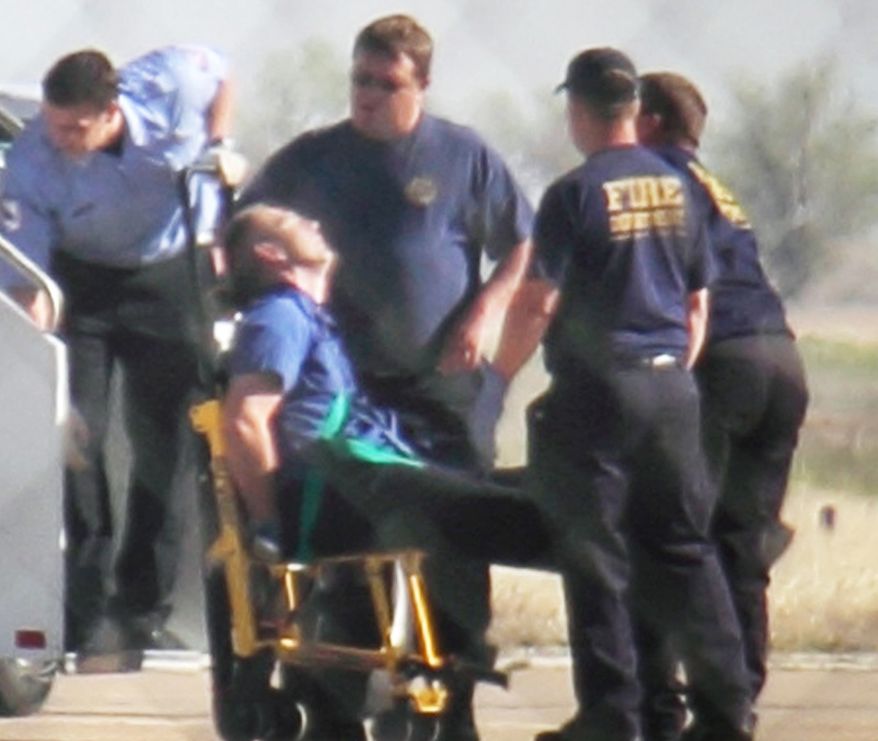 Emergency workers tend to a JetBlue captain that had a "medical situation" during a Las Vegas-bound flight from JFK International airport, Tuesday, March 27, 2012, in Amarillo, Texas. (AP Photo/Steve Douglas)